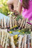 Child playing with a miniature garden