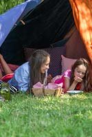 Children playing in garden den