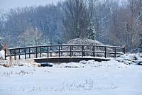 Wooden bridge in winter. Polish Academy of Sciences Botanical Garden -  Powsin/ Warsaw, Poland