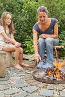 Firepit made from a dustbin lid with surrounding seating area