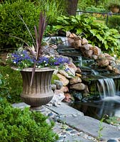 Pond with waterfall and mixed planting 