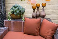 Outdoor living area, seating, candles and container with Kalanchoe marmorata, Sedum morganianum