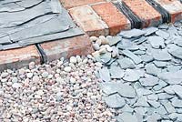 Detail of path made of assorted stone, old bricks and roofing slate