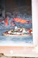 Pizza in self made pizza oven