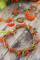 A woven heart wreath with Pyracantha berries