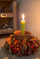 Candle holder decorated with Acer rufinerve leaves, Rose hips and Pyracantha berries