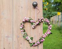 Decorative pink Snowberry heart wreath