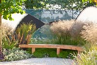Modern garden with shelter. Plants include Phormium, Deschampsia cespitosa, Deschampsia cespitosa 'Goldtau' and Thymus vulgaris