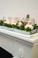 Christmas candle decorations arranged with christmas greenery