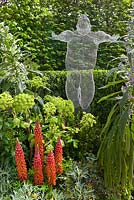 Sculpture 'Libertine' by Michelle Castles in The Arthritis Research UK Garden. Planting includes Angelica gigas, Echium, Lupinus 'Masterpiece' and Buxus sempervirens