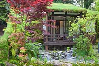 An Alcove Garden, Artisan gardens, a garden house with Sedum green roof surrounded by Acer palmatum, Chelsea Flower Show 2013