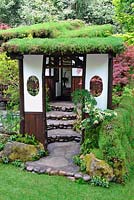 An Alcove - Tokonoma Garden. Entrance to the Japanese garden with living roof cover and sedum living wall