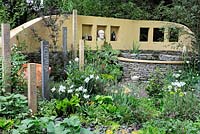 Raised pond, stone and rendered walls and flowering borders in the Get Well Soon garden