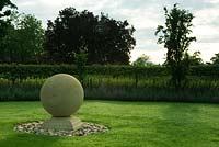 Stone sphere centrepiece  - summer garden,  Kirtling Tower, Suffolk 