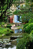 Japanese style garden - view to the east side of the house with pond, waterlilies, gravel garden, rocks and clipped scots pine