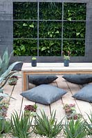 Outdoor living area with vertical planting and drought tolerant plants - 'The Austerity Garden' 