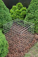Sculpture of metal cage over pine cones in the 'Woke From Troubled Dreams' Garden, BBC Gardener's World Live 2103