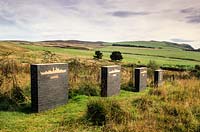 'Camouflaged Flowers'. View of the series of plinths. Little Sparta, Dunsyre, Lanark, Lanarkshire. Scotland.
