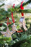 Cookie cutter bird feeders on a Christmas tree.