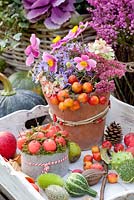 Autumnal arrangement with Malus, Cucumis, Aster laevis Calliope, Anemone hupehensis Splendens and Sedum Herbstfreude