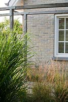 Beds of Molinia caerulea 'Dauerstrahl' and Panicum virgatum 'Rehbraun'.