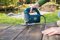 Using a jigsaw to cut decking to shape. 