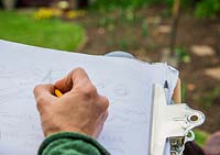 Woman sat in deck chair garden planning