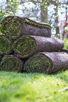 Pile of fresh turf rolls for resurfacing lawn