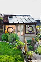 Lean to greenhouse made from architectural salvage building materials by Toby Buckland