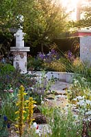 The M and G Garden (The Paradise Garden), Gold medal winner. RHS Chelsea Flower Show 2014., View of fountain surrounded by Stipa gigantea, Eremurus himalayicus