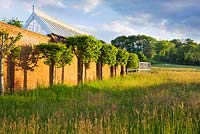 The meadow with the walled garden and glasshouse. Gipsy House, Buckinghamshire