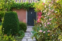 Pathway with roses, topiary and doorway 