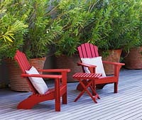 Decked terrace with red wooden chairs