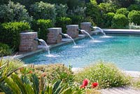 Modern contemporary garden - swimming pool with four brick water spouts. Les Confines, Provence, France

