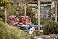 Colourful sun loungers in Mediterranean style beachside retreat with olive, pine and palm trees, 'En su Casa en la Playa - At Home on the Beach', show garden, RHS Malvern Spring Festival 2014