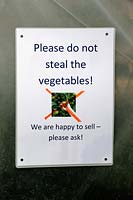 Sign saying - Please do not steal the vegetables -  St Mary's Secret Garden, a community garden in the London Borough of Hackney.