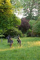 Bronze sculpture of children playing by Christine Charlesworth - Ramster Garden, Surrey