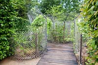 Title: Les Fleurs Maudites. Timber walkway with metal fences and frames