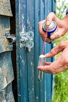 Lubricating rusty padlock on Allotment shed door