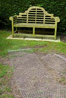 Repairing the lawn. Re-seeded with chicken wire laid over to protect from the birds