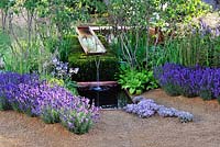 Vestra Wealth's Vista. Damp woodland planting with cantilever water chute and lavender at the edge of the small pool.