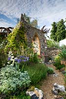 The Flintknappers garden - A story of Thetford. A gravel path curves towards door of ruined medieval priory church  Designer: Luke Heydon Sponsor: Thetford business community Silver-gilt award  