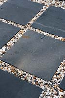 Contrasting textures of 20ml gravel Moonstone with slate natural stone paving in squares