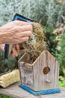 Remove nesting material from inside the birdhouse