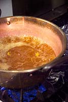 Making rosehip jam. Boil the strained  mixture with the sugar and lemon to a set.