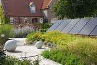A solar panel installation in a garden setting. August, Summer 2014.