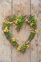 A heart shaped wreath with Sorbus berries and foliage