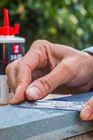 Using the sharpening stone push the blade of the knife away from you at an angle to sharpen the knife. Maintaining garden knife