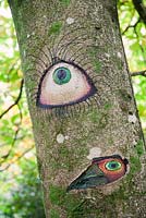 Someone's Watching Me by Peter Bye acrylic on tree. The Hannah Peschar Sculpture Garden designed by Anthony Paul, landscape designer