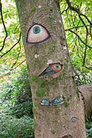 Someone's Watching Me by Peter Bye acrylic on tree. The Hannah Peschar Sculpture Garden designed by Anthony Paul, Landscape Designer